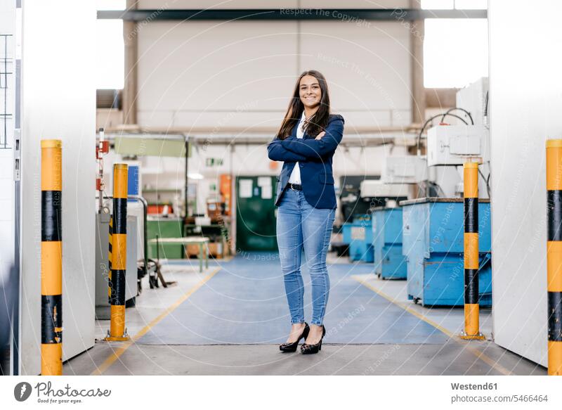 Confident woman working in high tech enterprise, standing in factory workshop with arms crossed Arms Folded Folded Arms Crossed Arms Crossing Arms Arms Clasped