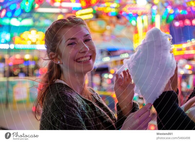 Portrait of happy redheaded teenage girl with candy floss at Oktoberfest in the evening Late Evening relax relaxing relaxation delight enjoyment Pleasant