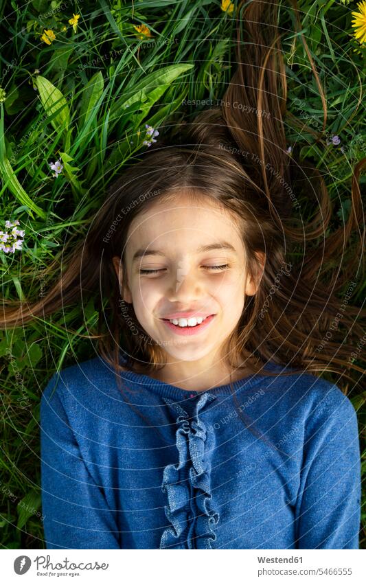 Portrait of girl with eyes closed relaxing on a meadow in spring jumper sweater Sweaters smile seasons spring season Spring Time springtime relaxation delight