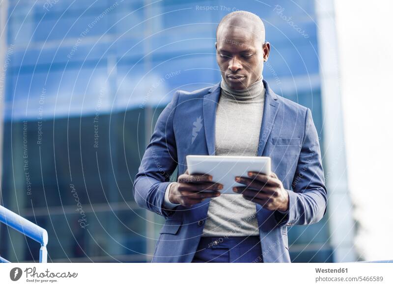 Portrait of smart businessman using digital tablet outdoors Businessman Business man Businessmen Business men use portrait portraits digitizer Tablet Computer