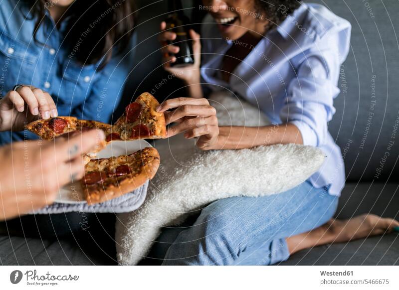 Close-up of cheerful friends drinking beer and eating pizza gaiety Joyous glad Cheerfulness exhilaration merry gay Pizza Pizzas Beer Beers Ale enjoyment