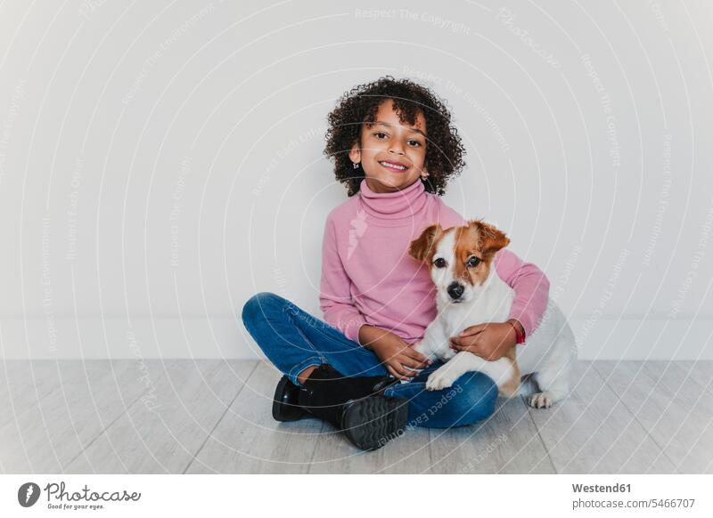 Portrait of smiling little girl sitting on the floor with her dog human human being human beings humans person persons 1 one person only only one person