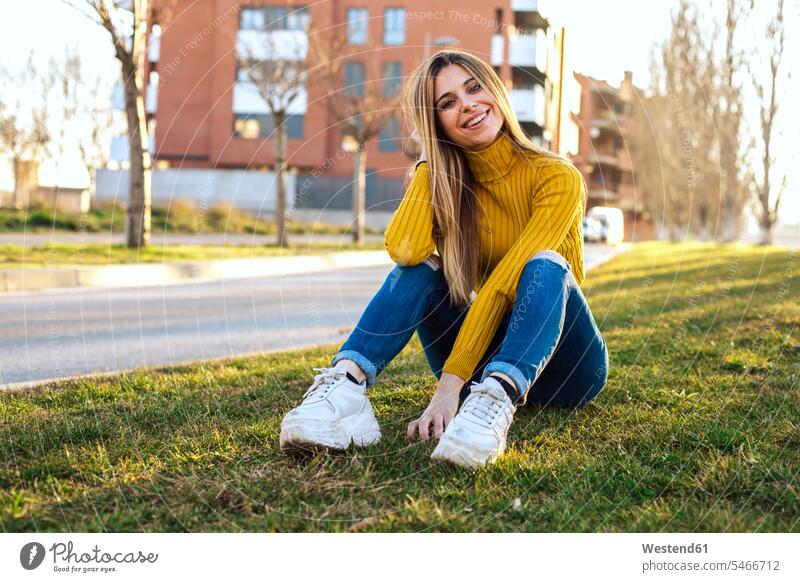 Portrait of smiling young woman wearing yellow turtleneck pullover smile portrait portraits females women Adults grown-ups grownups adult people persons