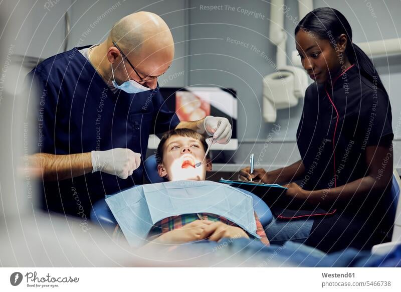 Boy receiving dental treatment health healthcare Healthcare And Medicines medical medicine patients Occupation Work job jobs profession professional occupation
