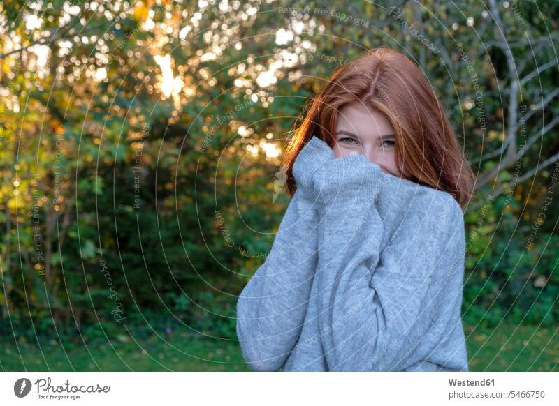 Portrait of teenage girl wearing grey pullover in autumn gray fall portrait portraits sweater jumper Sweaters Teenage Girls female teenagers colour colours