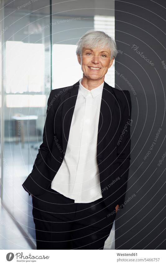 Portrait of smiling senior businesswoman wearing black pantsuit business life business world business person businesspeople business woman business women