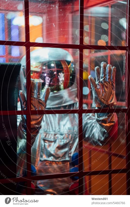 Spaceman trapped in a telephone box at night astronaut astronauts standing by night nite night photography telephone booth telephone kiosk callbox spaceman