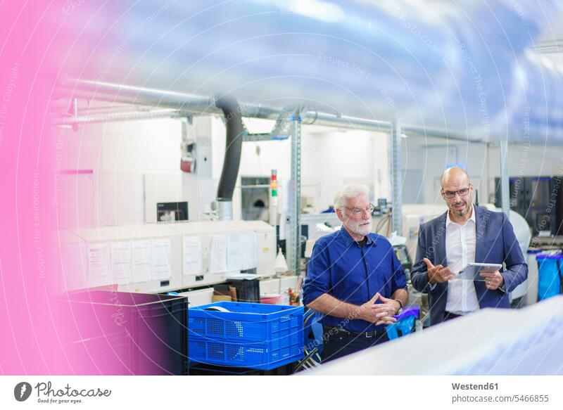 Male colleagues discussing while standing at laboratory color image colour image indoors indoor shot indoor shots interior interior view Interiors Germany