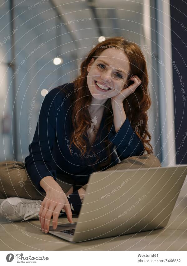 Portrait of smiling redheaded woman using laptop on the floor human human being human beings humans person persons caucasian appearance caucasian ethnicity