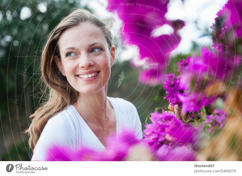 Portrait of happy woman with purple blossoms, Sardinia, Italy touch relax relaxing smile delight enjoyment Pleasant pleasure colour colours free time