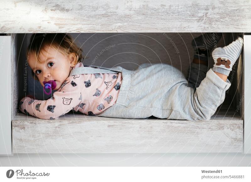 Portrait of baby girl with pacifier hiding at home infants nurselings babies portrait portraits hide Pacifiers comforter soother baby girls female people