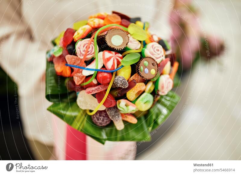 Close-up of woman holding candy bouquet females women Adults grown-ups grownups adult people persons human being humans human beings customer clientele clients