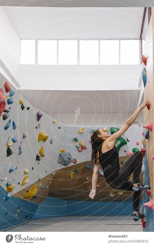 Woman bouldering in climbing gym (value=0) human human being human beings humans person persons caucasian appearance caucasian ethnicity european 1