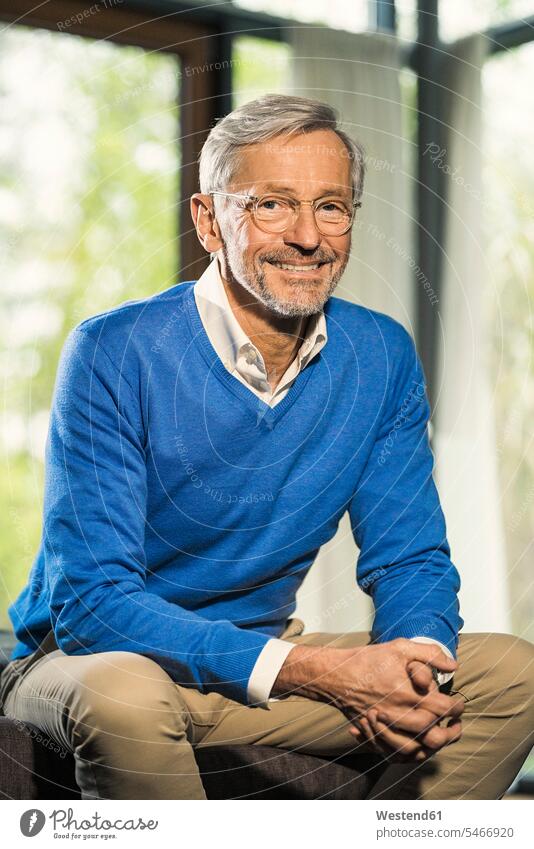 Portrait of smiling senior man at home human human being human beings humans person persons celibate celibates singles solitary people solitary person jumper