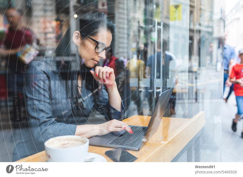 Business woman having a break in a cafe and working with a laptop human human being human beings humans person persons caucasian appearance caucasian ethnicity