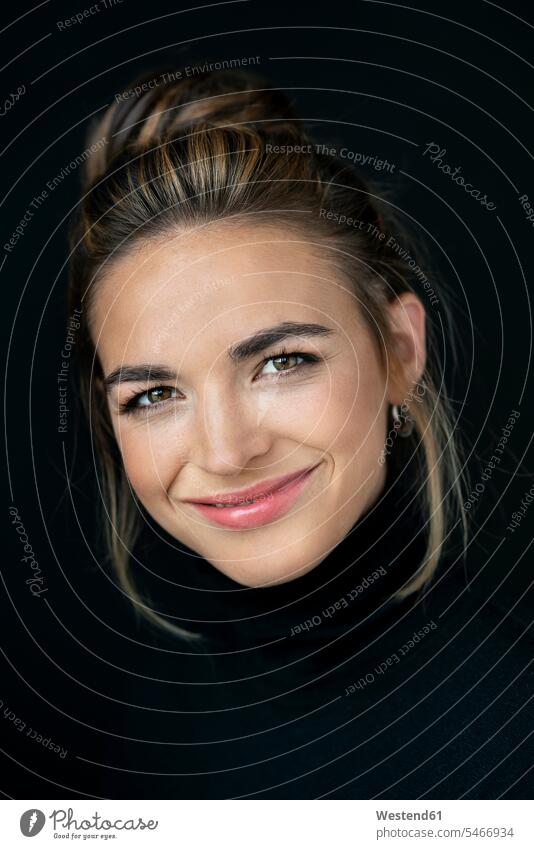 Portrait of beautiful woman against black background, looking at camera human human being human beings humans person persons caucasian appearance
