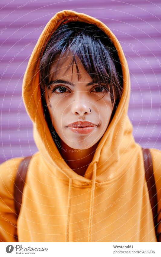 Portrait of young woman with yellow hoodie in front of purple background human human being human beings humans person persons 1 one person only only one person