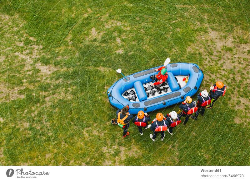 Top view of instructor talking to group of friends at a rafting class mate speak speaking free time leisure time protect protecting safe Safety secure community