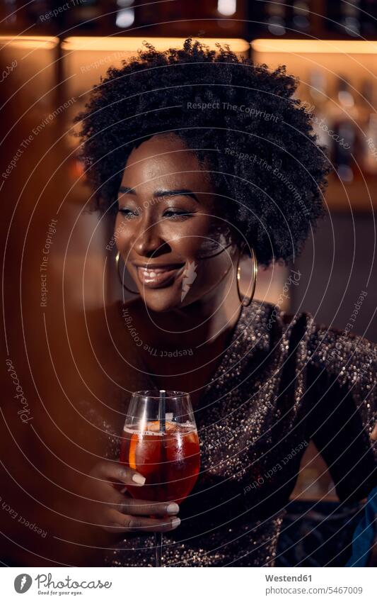 Portrait of woman having a cocktail in a bar human human being human beings humans person persons African black black ethnicity coloured caucasian appearance