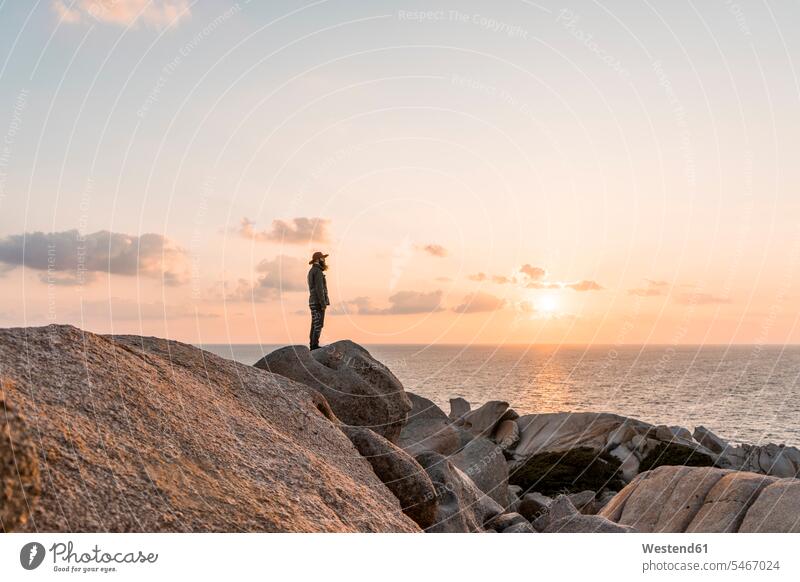 Italy, Sardinia, man standing on rock at sunset looking at view View Vista Look-Out outlook men males rocks seeing viewing Adults grown-ups grownups adult