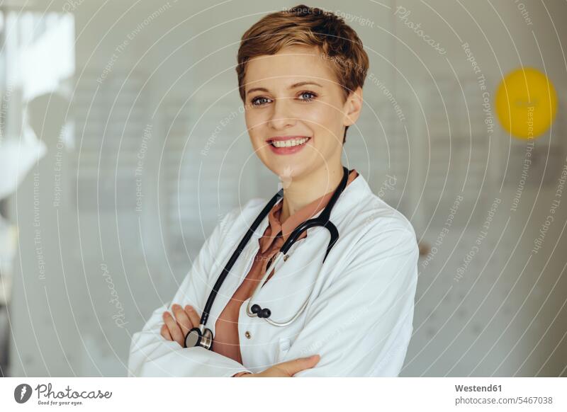 Portrait of a confident female doctor physicians doctors smiling smile portrait portraits Female Doctor Female Doctors medical practice medical practices