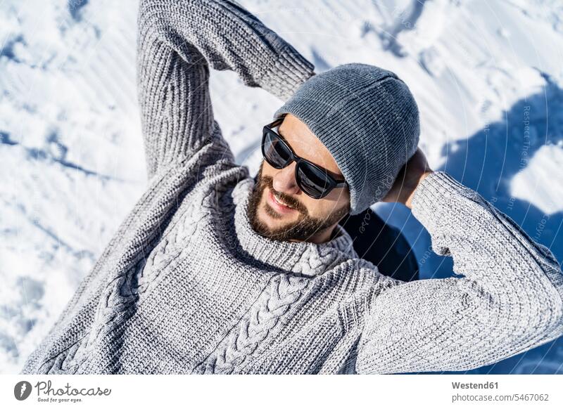 Happy man relaxing in winter hibernal happiness happy men males Adults grown-ups grownups adult people persons human being humans human beings Upper Bavaria