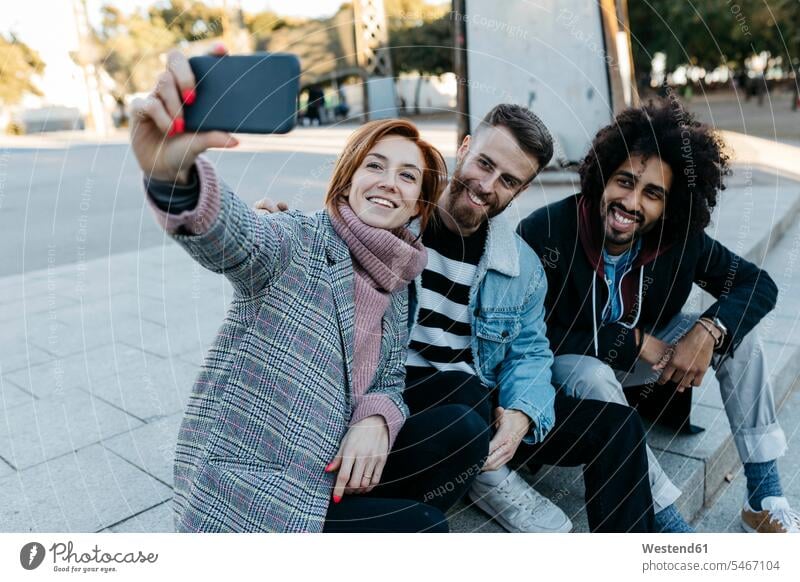 Three happy friends sitting outdoors taking a selfie Selfie Selfies happiness friendship Barcelona self-portrait Self Portrait Photography Photographing Self