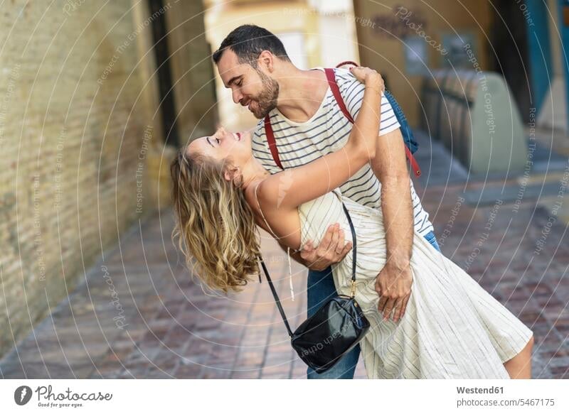 Spain, Andalusia, Malaga, happy couple hugging in the city twosomes partnership couples happiness town cities towns embracing embrace Embracement people persons