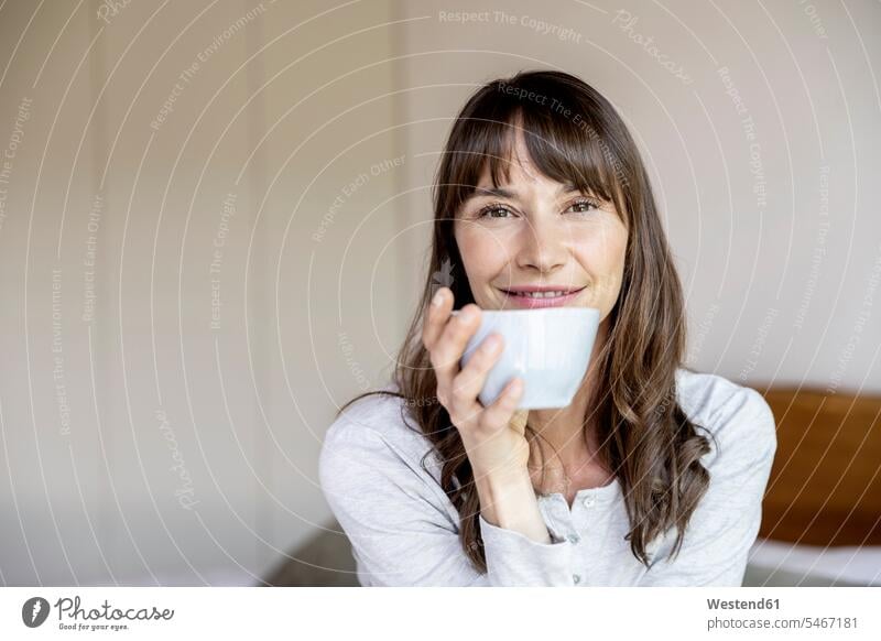 Portrait of relaxed woman holding cup of coffee at home human human being human beings humans person persons caucasian appearance caucasian ethnicity european 1