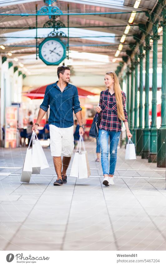 Young couple on a shopping spree bags shopping bags go going walk buy smile delight enjoyment Pleasant pleasure happy content Contented Emotion pleased