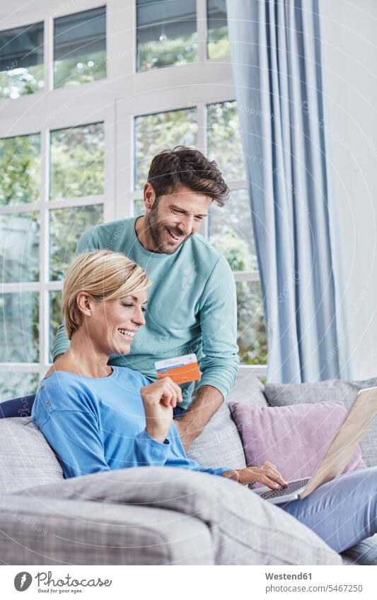 Happy couple at home shopping online online shopping on-line shopping happiness happy twosomes partnership couples Internet The Internet technology technologies