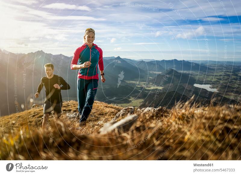 Sports people practicing trail running on mountain path of Saulingspitze at Bavaria, Germany color image colour image outdoors location shots outdoor shot