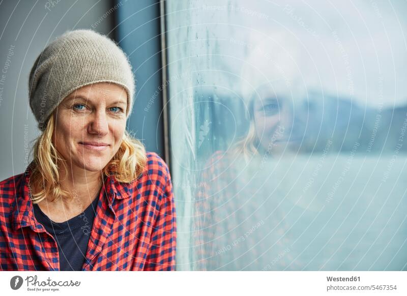 Chile, Hornopiren, portrait of woman at the window of a ferry portraits females women windows ship vessel water vehicle transportation Adults grown-ups grownups