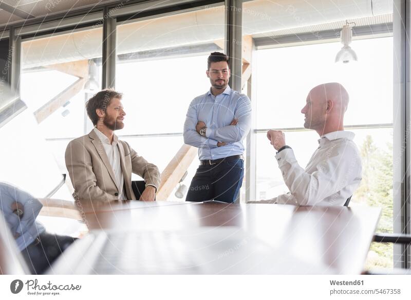 Three businessmen discussing in conference room discussion Businessman Business man Businessmen Business men meeting room conference rooms meeting rooms