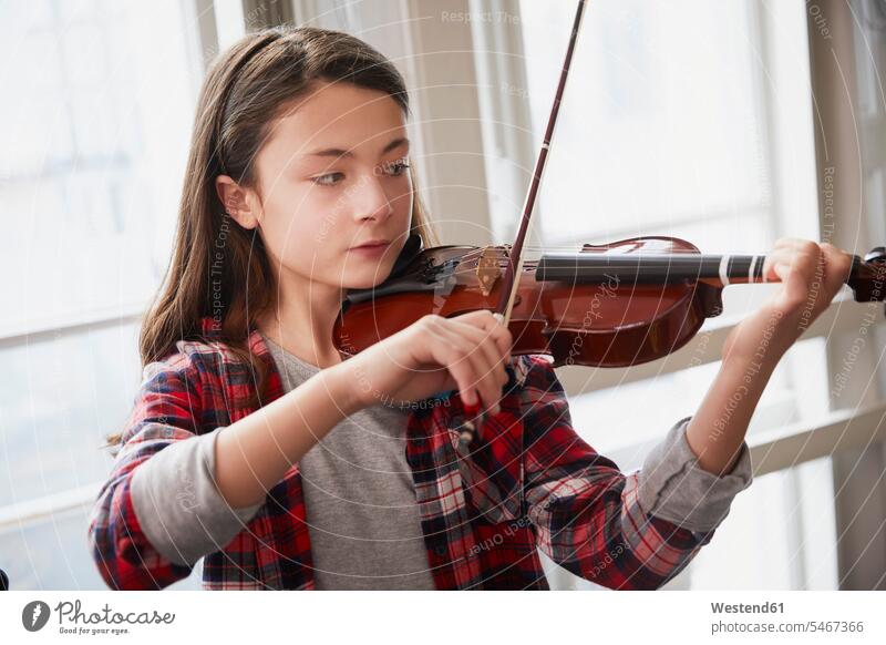 Girl playing violin during a lesson pupils schoolchild schoolchildren windows Instrument Instruments musical instruments stringed instruments violins learn