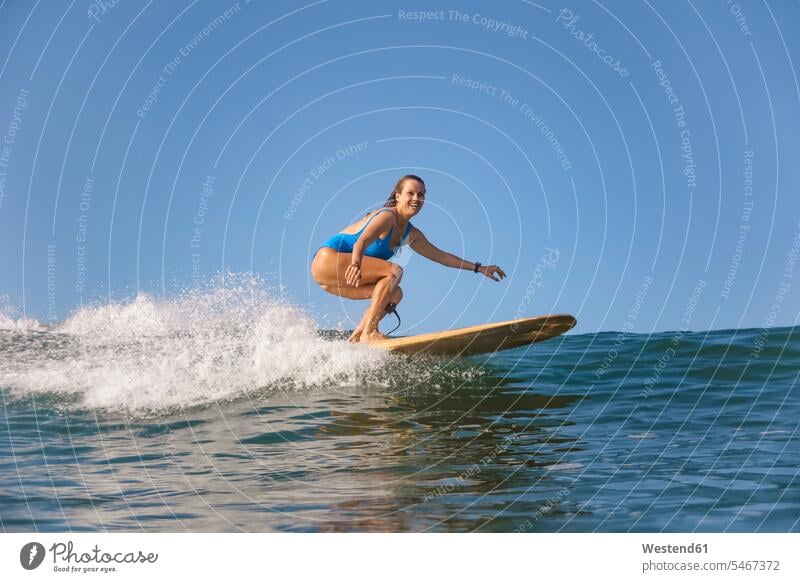 Indonesia, Bali, Batubolong beach, Pregnant woman, surfer in ocean female surfer surfers female surfers surfboard surfboards wave waves females women smiling