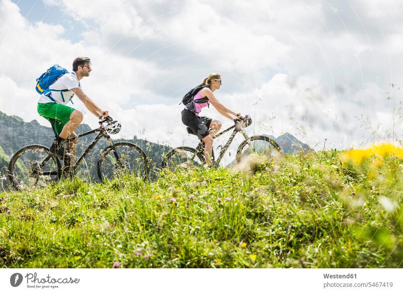 Couple mountainbiking in the mountains, Achenkirch, Austria back-pack back-packs backpacks rucksack rucksacks country country side countryside free time