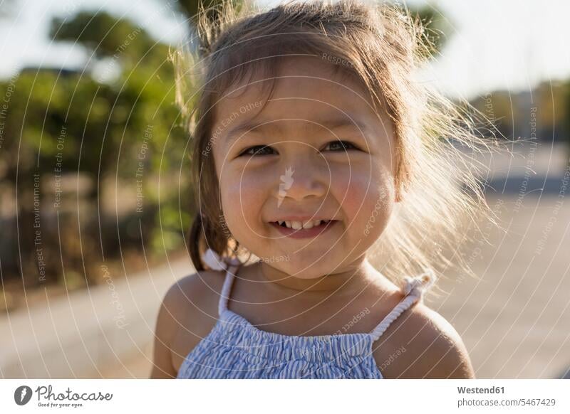 Portrait of happy little girl outdoors happiness females girls child children kid kids people persons human being humans human beings toothy smile big smile
