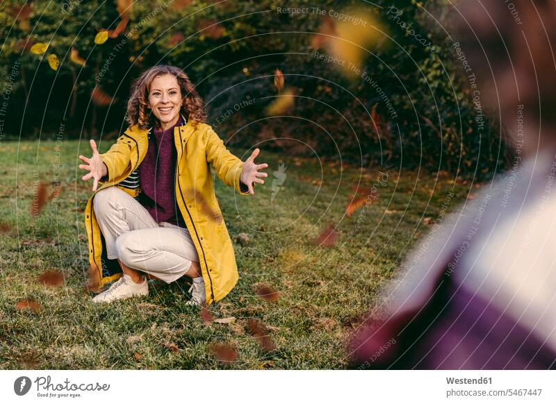 Happy mother awaiting daughter with open arms outdoors in autumn human human being human beings humans person persons caucasian appearance caucasian ethnicity