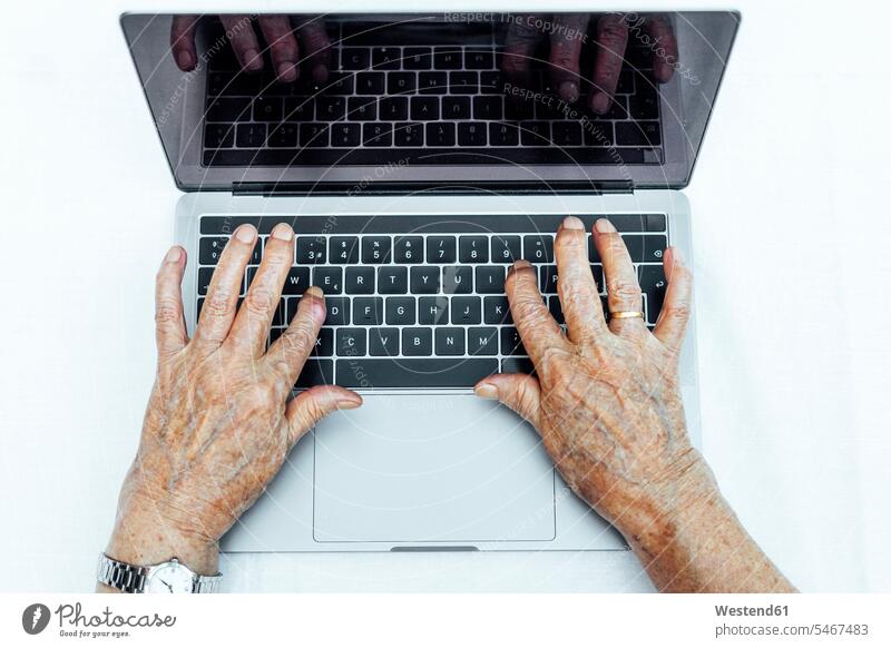 Close-up of senior woman's hands using laptop on table color image colour image Spain leisure activity leisure activities free time leisure time outdoors