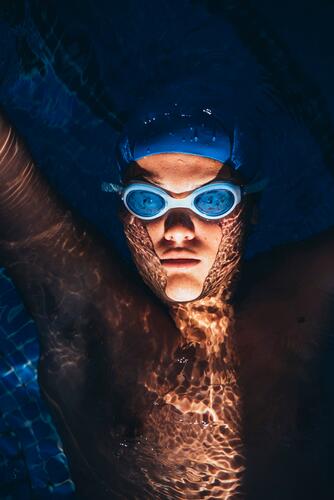 Portrait of paralympic young swimmer floating on water in a pool exercise practising train training colour colours sports free time leisure time