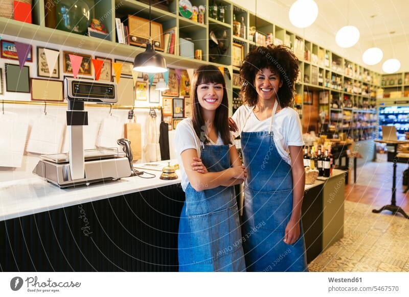 Portrait of two smiling women in a store portrait portraits shop woman females smile retail trade trading Adults grown-ups grownups adult people persons