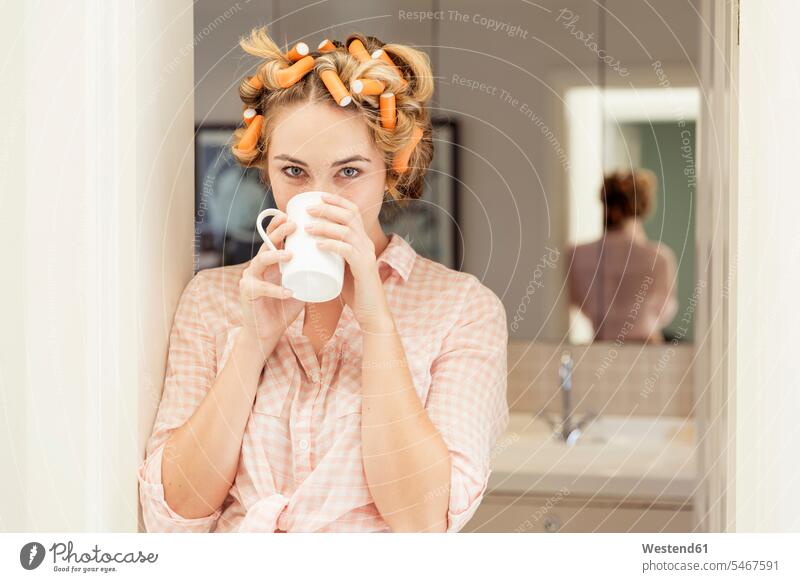 Portrait of young woman with curlers in hair drinking coffee human human being human beings humans person persons caucasian appearance caucasian ethnicity
