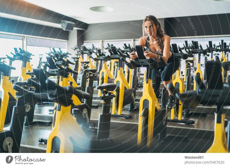 Woman in spinning class in gym human human being human beings humans person persons caucasian appearance caucasian ethnicity european Northern European 1