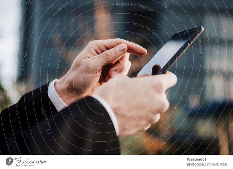 Close-up of businessman using smart phone outdoors color image colour image location shots outdoor shot outdoor shots Spain business people businesspeople