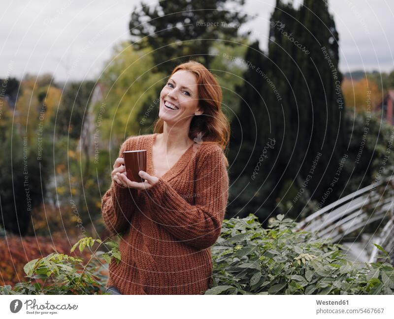 Woman standing on balcony, drinking coffee human human being human beings humans person persons caucasian appearance caucasian ethnicity european 1