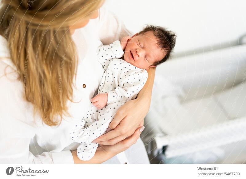 Newborn baby in mother's arms multicultural Part Of partial view cropped shirt shirt blouse dreaming Dream Dreams happiness happy eyes closed closed eyes