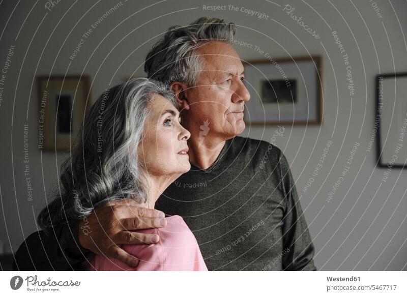 Portrait of a senior couple at home frame frames picture frames images pictures relax relaxing embrace Embracement hug hugging relaxation Emotions Feeling