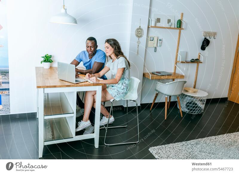 Couple using laptop at home human human being human beings humans person persons caucasian appearance caucasian ethnicity european African black black ethnicity