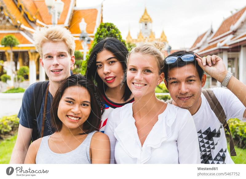 Thailand, Bangkok, group picture of five friends visiting temple complex Temple complex Group Portrait group foto friendship temples building buildings